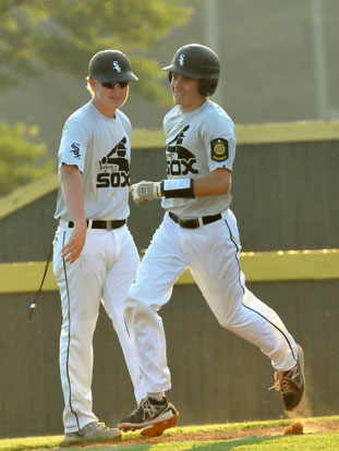 Bryant's Evan Lee is congratulated by his coach Tyler Brown on his way home after slugging a two-run homer. (Photo by Kevin Nagle)
