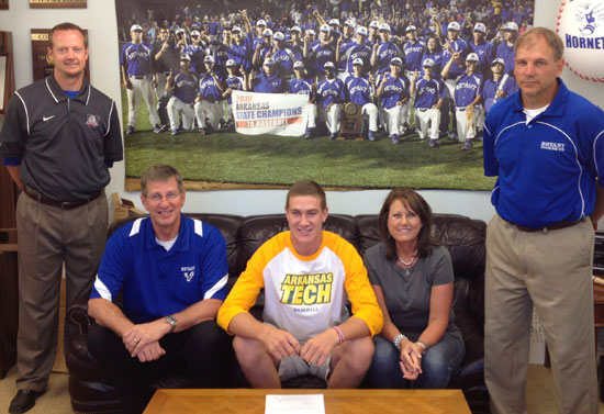 Nate Rutherford is flanked by his parents Randy and Robbie Rutherford with pitching coach Steve Tharp, left, and Hornets head coach Kirk Bock standing by as he signs his letter of intent with Arkansas Tech.