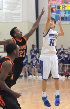 Garrett Cowart launches a shot beyond the reach of Malvern's Jacquez Lock (23). (Photo by Kevin Nagle)