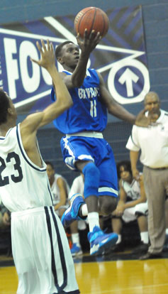 Kevin Hunt drives past Fair's Tony Campbell (23). (photo by Kevin Nagle)