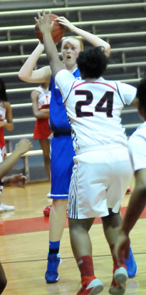 Rachel Miller prepares to fire up a shot over Pine Bluff's Chasity Moore (24). (photo by Kevin Nagle)