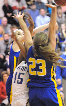 Bryant's Jayla Anderson gets crunched between a pair of Sheridan players under the basket. (PHoto by Kevin Nagle)