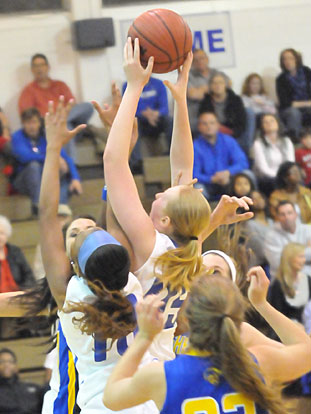 Bryant's Rachel Miller reaches high to pull down a rebound in a crowd. (Photo by Kevin Nagle)