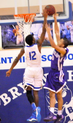 Cedarrian Crosby (12) goes high to block a shot. (Photo by Kevin Nagle)