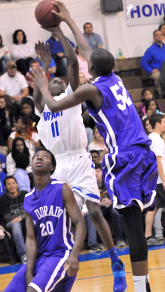 Kevin Hunt (11) scored 19 points but not on this play as El Dorado's 6-10 Matthew Horton (54) rejects his shot. (Photo by Kevin Nagle)