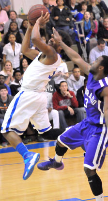 C.J. Rainey (3) reaches back to take a shot. (Photo by Kevin Nagle)