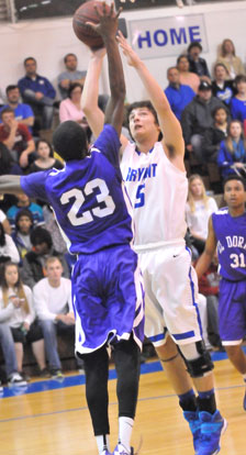 Bryant's Caleb Strain (5) tries to get a shot over El Dorado's Jalen Cunningham. (Photo by Kevin Nagle)