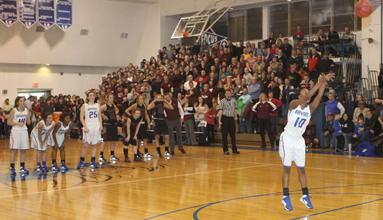 The Bryant Lady Hornets and Benton Lady Panthers watch pensively as Bryant's Jakeria Otey launches a free throw with no time left in the game. She converted both shots to make the Lady Hornets 51-50 winners. (Photo by Rick Nation)