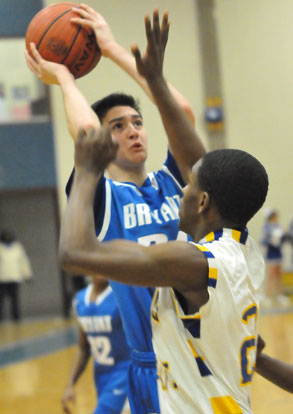 Kyle Sahr attempts a jumper over North Little Rock's Taleh Wade. (Photo by Kevin Nagle)