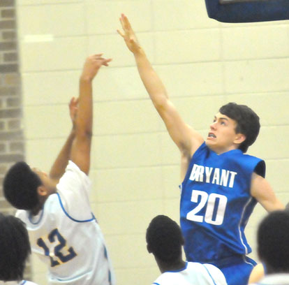 Grayson Prince (20) tries to block a North Little Rock shot. (Photo by Kevin Nagle)