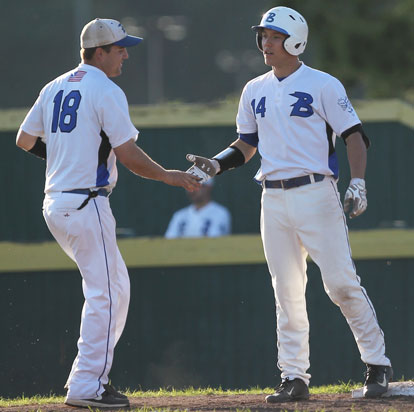 Bryant third base coach Travis Queck, left, congratulates Brandan Warner after his two-run triple in the fourth inning Wednesday. (Photo by Rick Nation)