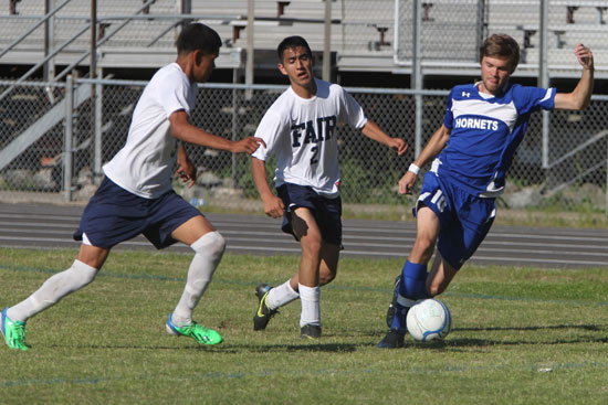 Evan Caddy works the ball up the field. (Photos by Rick Nation)
