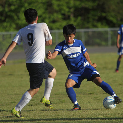 Krisha Gurung, right, maneuvers around a Fair player. (Photo by Rick Nation)