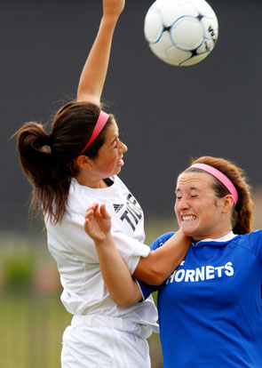 Bentonville's Gia Diaz (left) and Bryant's Kara Taylor vie for a header on Saturday, May 24, 2014, in the Class 7A championship game at Razorback Field in Fayetteville. (Photo courtesy of Jason Ivester/NWA Newspapers LLC)