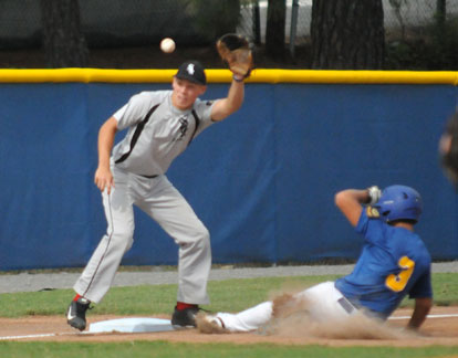 Jordan Gentry takes a throw at third as Sheridan's David Vilches slides in safely. (Photo by Kevin Nagle)