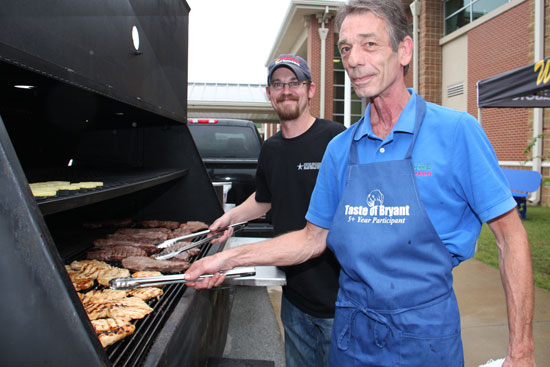 Greg Gabriel, left, and Brian Jones from Colton's Steakhouse check out the grilled steak and chicken. (Photo by Rick Nation)