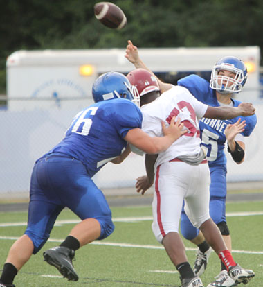 Cameron Vail tosses a pass as teammate Kobi Riffe (76) blocks Pine Bluff's Duncan Bailey. (Photo by Rick Nation)