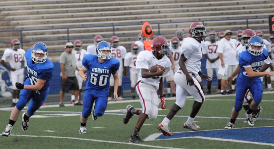 The Hornets, including Trace Talley (60) pursue a Pine Bluff Robey running back. (Photo by Kevin Nagle)