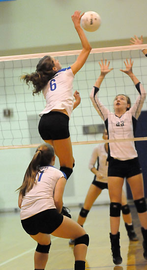 Allie Anderson goes high to spike the ball. (Photo by Kevin Nagle)