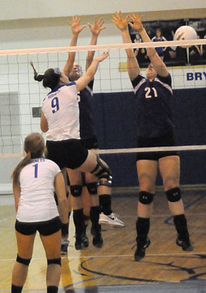 Kendall Selig (9) follows through on a hit over a pair of Mount St. Mary defenders as Madison Greeno gets position to play a block. (Photo by Kevin Nagle)