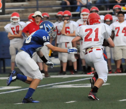 The Hornets' Logan Grant (88) bears down on Cabot North running back Mason Martin. (Photo by Kevin Nagle)