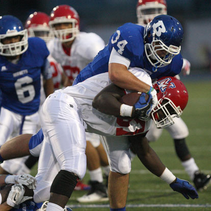 Hayden Knowles (34) makes a tackle for a loss. (Photo by Rick Nation)