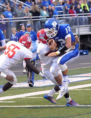 Brandan Warner (12) tries to fight through a tackle. (Photo by Kevin Nagle)