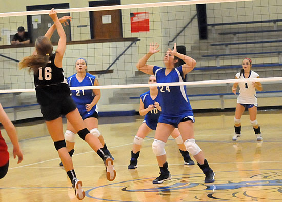 Ellen Barnes (24), Ally Benoit (21), Madi Draper (10) and Sidney Bosswell (1) prepare to receive a Cabot South hit. (Photo by Kevin Nagle)