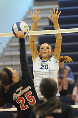 Emily Clem goes up for a block. (Photo by Kevin Nagle)
