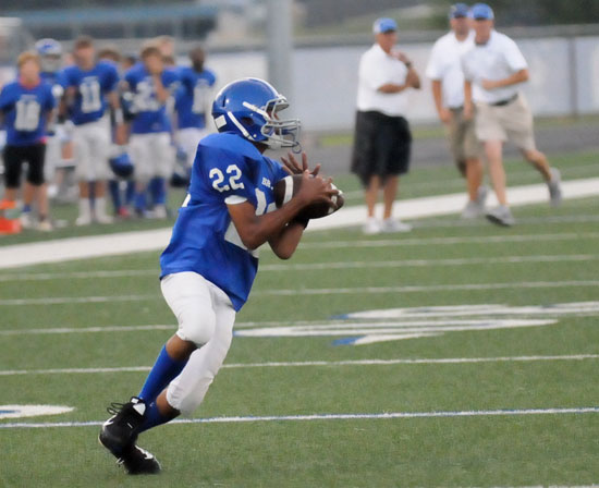 Hornets coach Brad Smothermon reacts in the background as Andrew Hayes hauls in a pass that broke for a 42-yard touchdown. (Photo by Kevin Nagle)