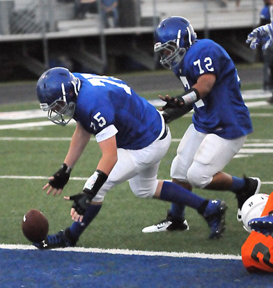 Blaise Smith (75) scoops up a loose ball after he blocked a Cloverdale punt. Teammate Josh Salguerio (72) provides an escort. (Photo by Kevin Nagle)