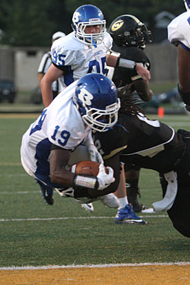 Bryant's Kylon Boyle (19) gets across the goal line despite a hit from Central linebacker Malcolm Williams (2) after picking up a block from tight end Austin Fisher (95). (Photo by Rick Nation)