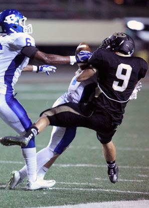 Drew Tipton drives through Central receiver Tom Coulton (9) to break up a pass as Brenden Young (6) arrives. (Photo by Rick Nation)