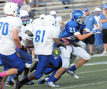 Grant Botti (21) muscles through a group of Lakewood defenders. (Photo by Kevin Nagle)