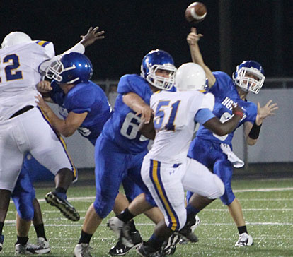 Behind protection for his offensive line including Preston Kyzer (68) on Deontray Ross (51), Bryant quarterback Michael Jones fires a pass. (Photo by Rick Nation)