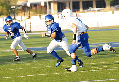 Lakewood's Drew Martin, right, is tracked by Bryant White's Brandon Jett (5) and Ryan Lessenberry (15). (Photo by Kevin Nagle)