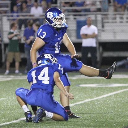 Alex Denker (13) kicks one of his field goals out of the hold of Madison Schrader (14). Denker hit three field goals, four extra points, had three touchbacks on kickoffs and averaged 38.5 yards on two punts. (Photo by Rick Nation)