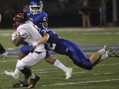 Bryant linebacker Kyle Lovelace (32) hits Russellville running back Kentrell Scott as Brenden Young (6) arrives to help out. (Photo by Rick Nation)