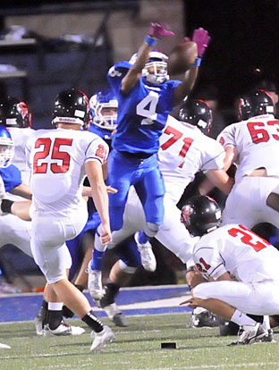 Mark Nelson (4) blocks a field goal attempt. (Photo by Kevin Nagle)