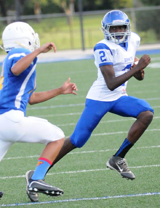 Randy Thomas works to avoid an Immaculate Conception tackler. (Photo by Kevin Nagle)