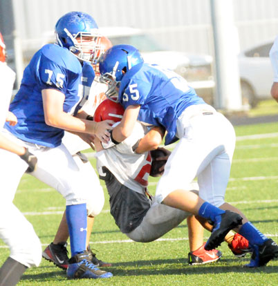 Jakob Neel (55) and Blaise Smith (75) get in on a tackle. (Photo by Kevin Nagle)