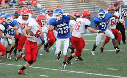 Brooks Ellis (33), Johnny Smith (9) and Nick Smith (55) lead Bryant's pursuit of Cabot South's Cody Skinner. (Photo by Kevin Nagle)