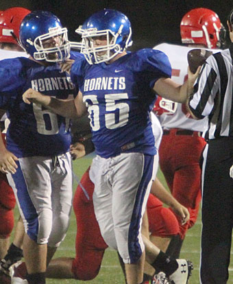 Hunter Howard (65) hands the ball to the referee after recovering a Cabot South fumble. (Photo by Rick Nation)