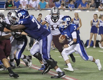 Gunnar Burks (3) looks for room to run off of the block of Cameron Davis (77). (Photo by Rick Nation)