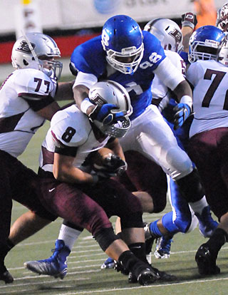 Cameron Murray (98) looms over Benton running back Drew Dyer. (Photo by Kevin Nagle)