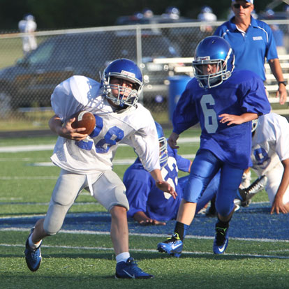 Bryant White's Damien Constanino (28) is pursued by Bryant Blue's River Holland (6). (Photo by Rick Nation)