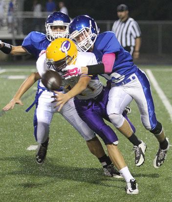 Bryant's Cameron Vail (5) knocks the ball loose as he hits Catholic quarterback Nathan Page. (Photo by Rick Nation)