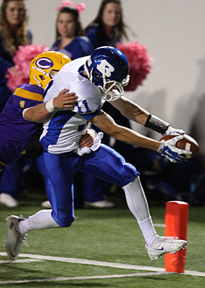 Wide receiver Evan Lee stretches the ball across the goal line to finish off a touchdown pass play against Little Rock Catholic. (Photo by Rick Nation)