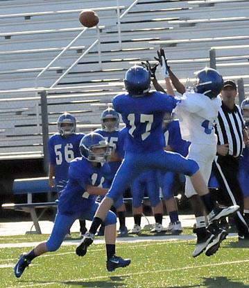 Defensive back Matt Curtis (17) goes up to try to knock away a pass before it reaches the Bryant White receiver. (Photo by Kevin Nagle)