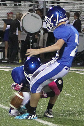 Luke Welch kicks an extra point out of the old of Cameron Vail. (Photo by Rick Nation)